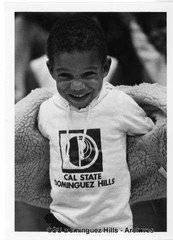 Child showing off CSUDH sweatshirt