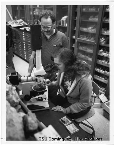 Geology student at microscope