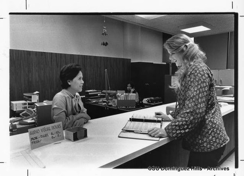 Roberta Quinte assists at the Audio-Visual front desk