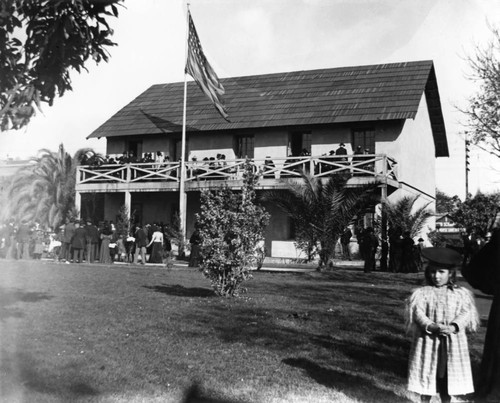 State House replica with people on balcony