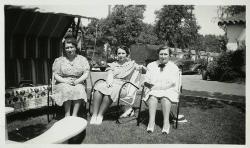 1940, Three Library Staff sitting outside in Lawn Chairs