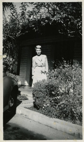 1940, Kathryn Williams standing in front of a brick building