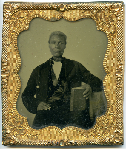 Portrait of unidentified man holding book