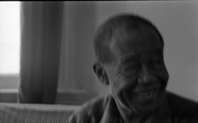 Blues musician Jesse Fuller in his home