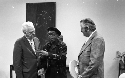 Blues musician Jesse Fuller speaking with KPIX general manager Al Constant (left) and former museum director John Peetz during concert at the Oakland Museum