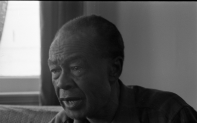 Blues musician Jesse Fuller in his home