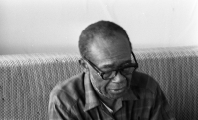 Blues musician Jesse Fuller in his home