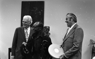 Blues musician Jesse Fuller laughing with KPIX general manager Al Constant (left) and former museum director John Peetz during concert at the Oakland Museum