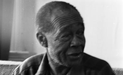 Blues musician Jesse Fuller in his home