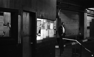 Woman paying at parking garage attendant booth