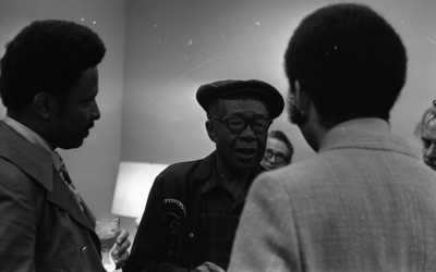 Jesse Fuller speaking with tv host and newsman Ray Taliaferro (right) and unidentified man after his concert at the Oakland Museum