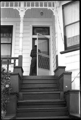 Jesse Fuller opening door to his house at 1679 11th St, Oakland, California