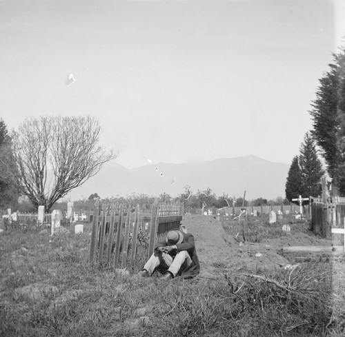 Man sitting by grave