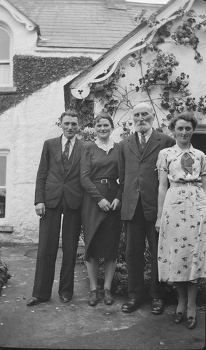 Group of people in front of building [probably in Ireland]