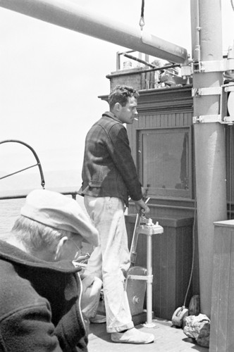 Roger Revelle (standing) and Erik Gustaf Moberg on the deck of R/V Scripps