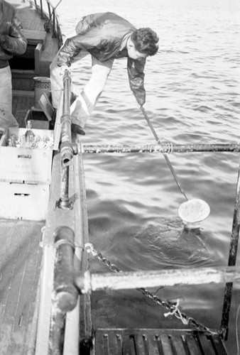 Hiomi Nakamura with dip net aboard R/V Scripps