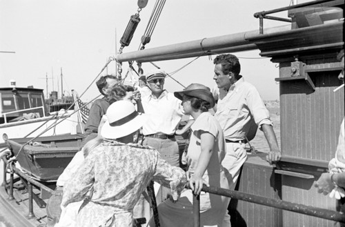 Martin Wiggo Johnson (in hat), and Roger Revelle with his wife, Ellen Virginia Clark Revelle, leaving on a cruise aboard the R/V Scripps from the San Diego Yacht Club