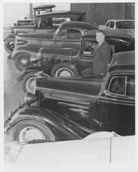 Pete Pellini and his antique car collection at Pellini Chevrolet, about 1970