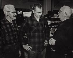 Fr. Boeddeker speaking to two men at St. Anthony's Dining Room, 121 Golden Gate Avenue, San Francisco, California, February 1979