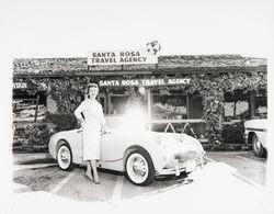 Claire C. Bramwell and her Sprite in front of Santa Rosa Travel, Santa Rosa, California, 1959