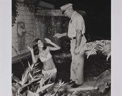 Sheriff and bikini-clad girl at the Hall of Flowers at the Sonoma County Fair, Santa Rosa, California, 1972