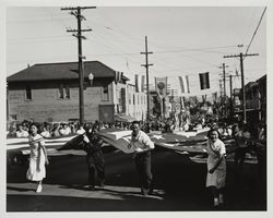 Japanese American group pulling a large American flag down Bodega Avenue