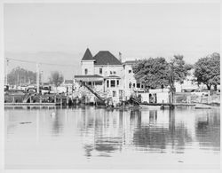 Dredger working beside the Farrell House in Petaluma, California