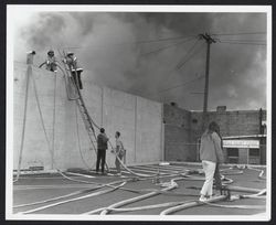 Petaluma Fire Department firefighters fighting unidentified fires, Petaluma, California, about 1965