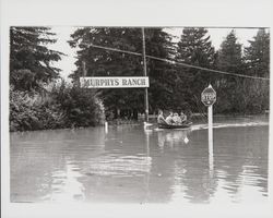 People in a rowboat at Murphy's Ranch during a flood