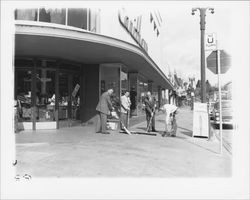 Businessmen sweeping the sidewalk in front of Carithers Department Store, Petaluma, California, about 1952