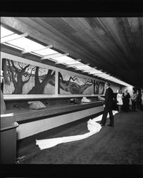 Gordy Soltau looking at paintings by Ruth Dicker at grand opening of the Bank of Sonoma County, Santa Rosa, California, 1973