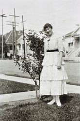 Ethel Raymond standing in front of her family's house, 245 Keokuk Street, Petaluma, California, about 1920