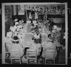 Children dressed as Pilgrims and Indians at the Thanksgiving Party in their kindergarten classroom