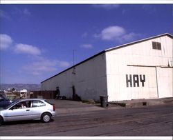 Parking lot and warehouse at 425 First Street, Petaluma, California, with Sunset Line & Twine in the background across the Petaluma River, Sept. 25, 2001