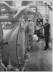 Chief Engineer Fran Burke at the controls of two low-pressure boilers at Hillcrest Hospital, Petaluma, California, December, 1956