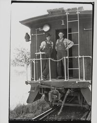 Wayne Williams and Mac McAurich standing at the back of a train, Forestville, California, 1937