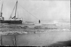 Unidentified ship aground near an unidentified beach, about 1900