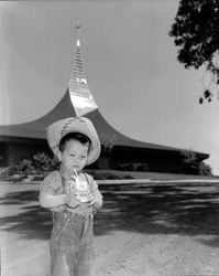 Boy drinking a carton of Foremost milk in the parking lot of 150 Saint Joseph Catholic Church, Cotati, California, 1965