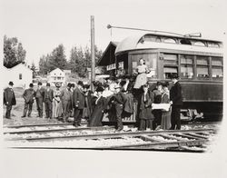 McNear family members and friends stand by a Petaluma and Santa Rosa Railway Company train stopped at the Forestville Station, California, about 1910