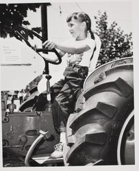 Julie Bulbeck drives a tractor at the Sonoma County Fair, Santa Rosa, California