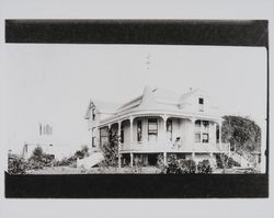 Unidentified two-story Queen Anne Victorian home with curving porch topped with a conical tower, 1950s or 1960s