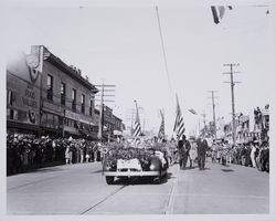 Car of the Grand Marshall followed by a band in the Gravenstein Apple Show parade