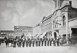 Group of firefighters standing at attention in front of the City of Santa Rosa City Hall, located on Hinton Avenue between Third and Fourth Streets, about 1890