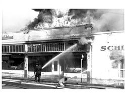 Send water into the burning Rex Hardware and Schindler Bakery buildings, Petaluma, California, Jun. 21, 1942