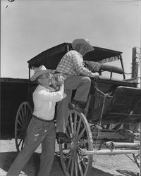 Leo Schoeningh shoving Milt Gustafson aboard a stage coach, Petaluma, California, about 1961