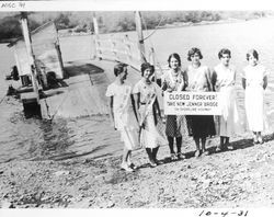 Bay Area beauty queens with sign closing the ferry crossing of the Russian River