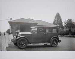 Justena E. Long and her husband Frank Kelly sit in their car at the Santa Rosa Train Depot, Santa Rosa, California, 1930s