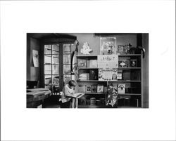 Carmen Finley reading a book in the Children's Room of the Library, Santa Rosa, California, 1934