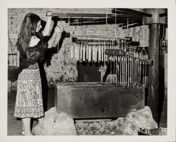 Linda Margarain performs many chores at the Petaluma Adobe, including spinning, grinding corn, candlemaking, baking, etc, Petaluma, California, 1977