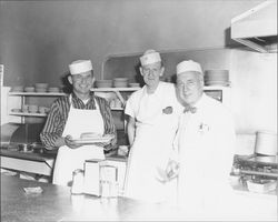 Men serving pancakes in an unidentified restaurant, Petaluma, California, about 1953
